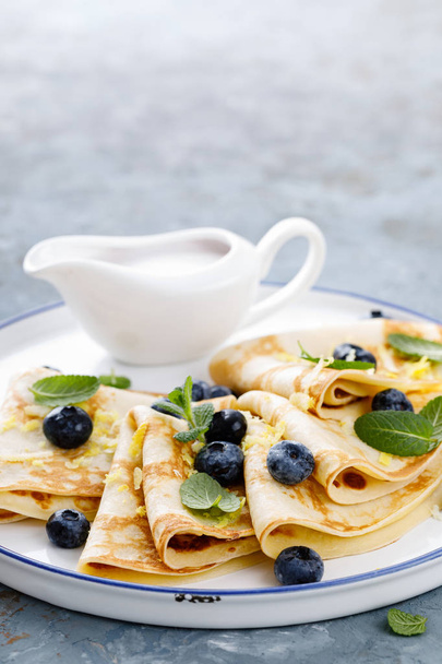 Sweet pancakes wrapped with fresh berries, crepes with blueberry - Photo, Image