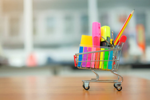 Back to school and Education concepts with shopping cart, pencil, highlighter and notepad - Photo, Image