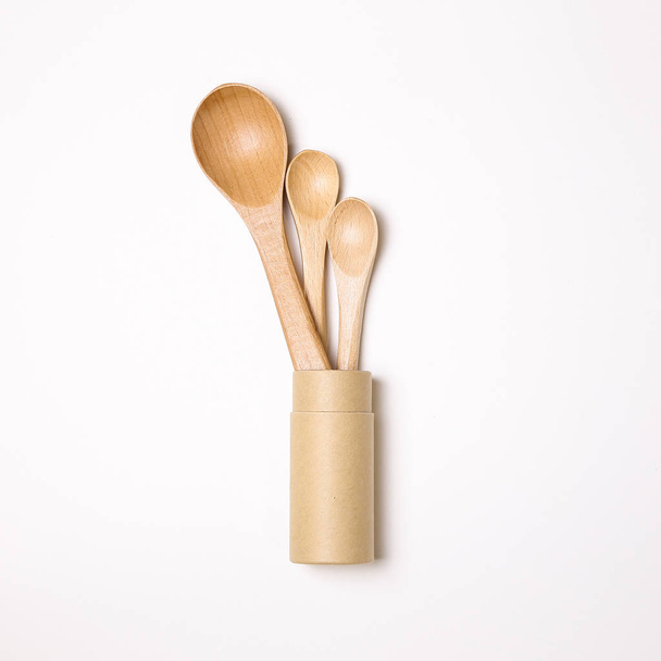 Wooden spoons in holder on white background - Fotó, kép