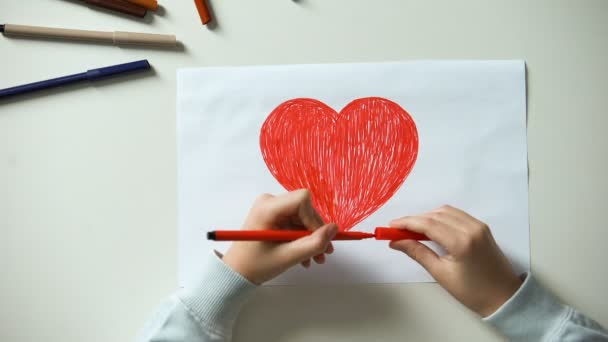 Kid painting red heart, putting wooden cubes with love word, true relationships - Séquence, vidéo