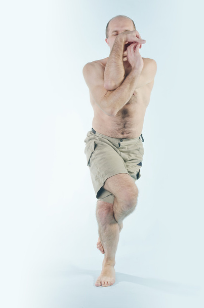 Portrait of man in yoga pose - Foto, Bild