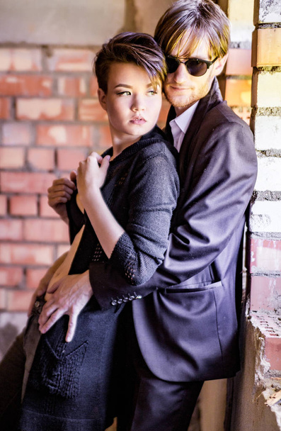 sexy guy and girl on brick wall background - Foto, imagen