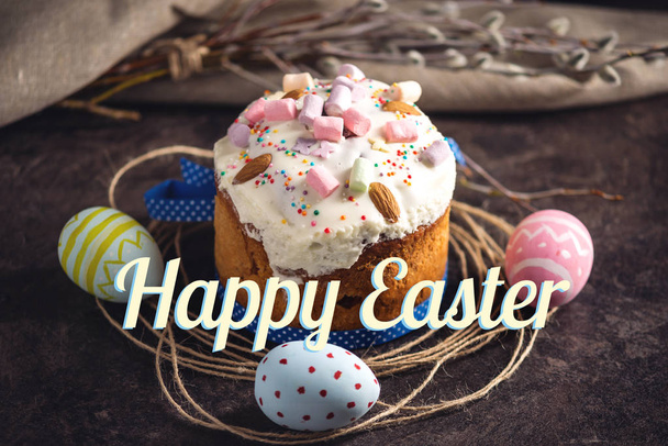 Traditional Easter cake and colorful eggs and text in rustic style on a dark background. Concept holiday card - Foto, immagini
