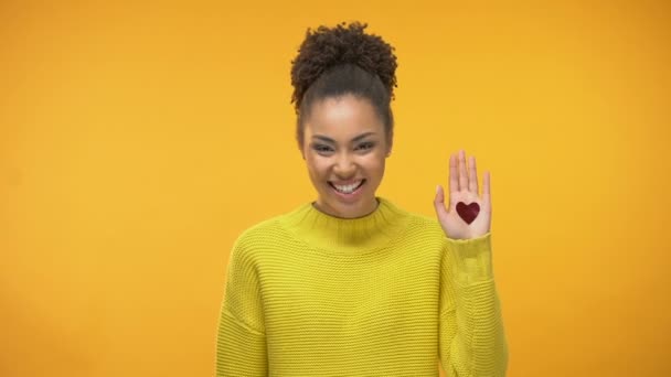 Happy black woman showing open palm with heart sign, sincere love, relationships - Záběry, video
