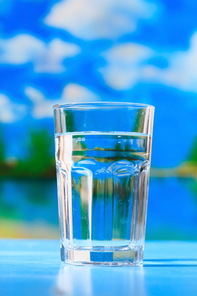 Glass of the water on the beach - Фото, зображення
