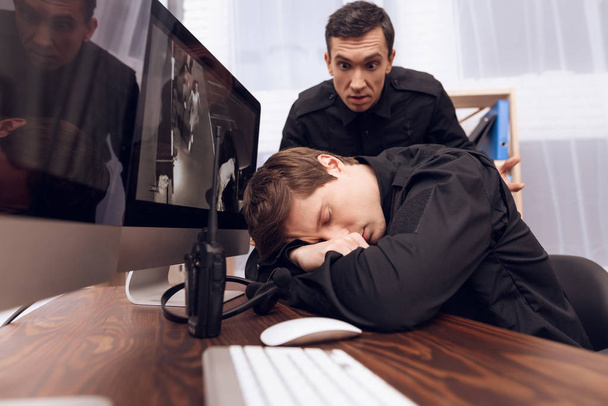A man guard is sleeping in the workplace. - Фото, зображення