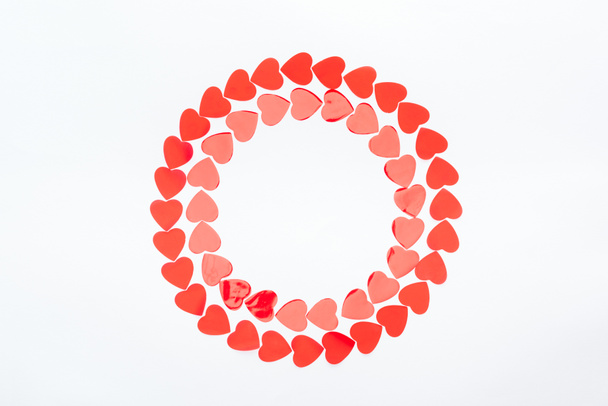 Draufsicht des runden Rahmens mit roten Papierherzen isoliert auf weißem, Valentinstag-Konzept - Foto, Bild