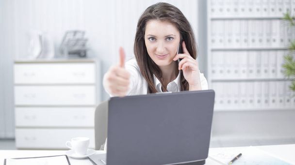 successful business woman showing thumb up in the workplace - Photo, Image