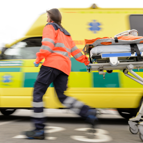 Running blurry paramedic woman pulling gurney - Foto, Imagem