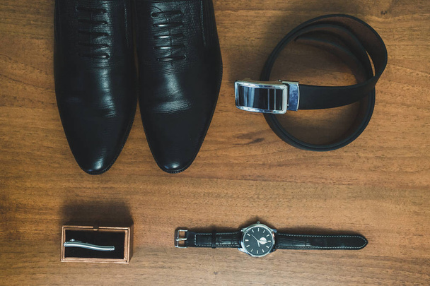 Men's accessories: watch, tie, belt, shoes top view. - Фото, зображення