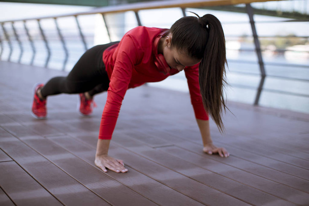 Giovane donna esercizi sul lungomare dopo la corsa al mattino
 - Foto, immagini