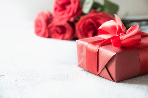 Valentines card with red gift box, romantic roses on white. Space for text. Close up. - Фото, зображення