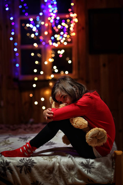 sad and tearful girl sitting with a teddy bear - Фото, зображення