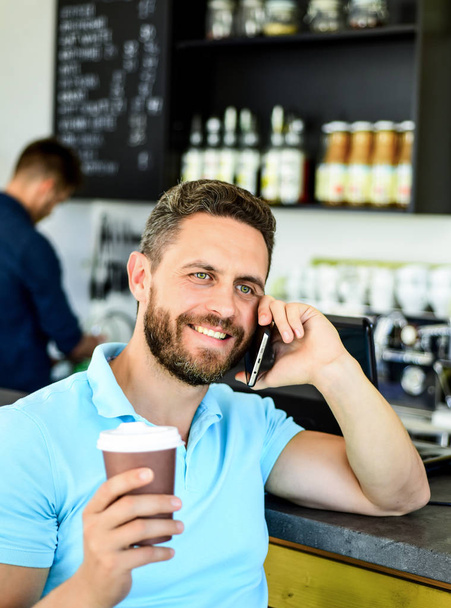 Man smartphone order coffee in cafe. Coffee break concept. Coffee take away option for busy people. Man mobile conversation cafe barista background. Drink coffee while waiting. Waiting for you - Zdjęcie, obraz
