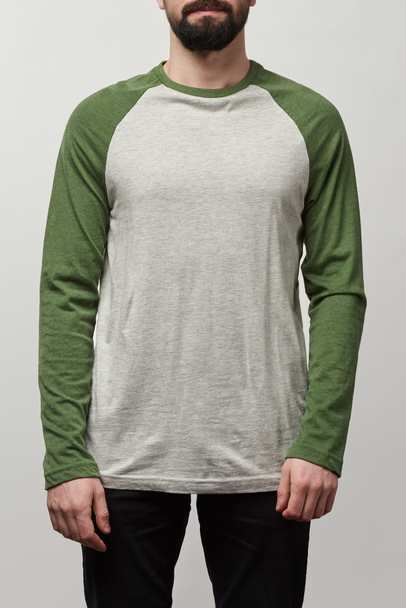 partial view of man in basic raglan sleeve baseball shirt with copy space isolated on grey - Photo, Image