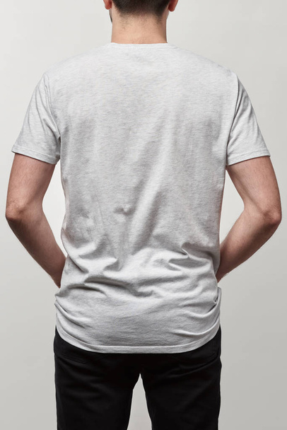 back view of man in casual white t-shirt with copy space isolated on grey - Φωτογραφία, εικόνα