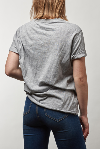 back view of young woman in basic grey t-shirt with copy space isolated on white - Φωτογραφία, εικόνα