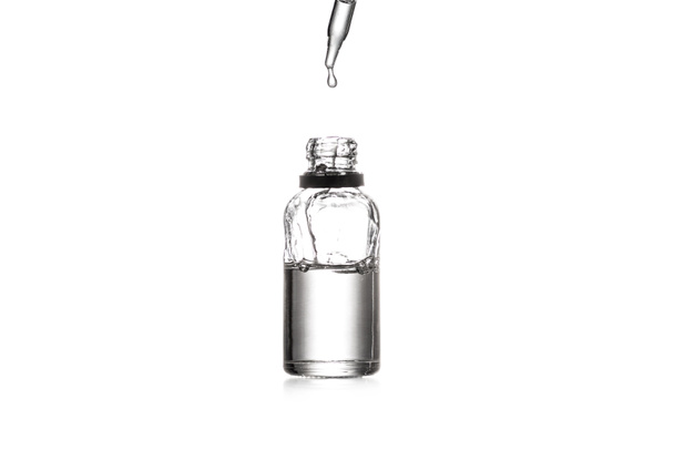 Studio shot of opened glass bottle and dropper isolated on white - Photo, Image