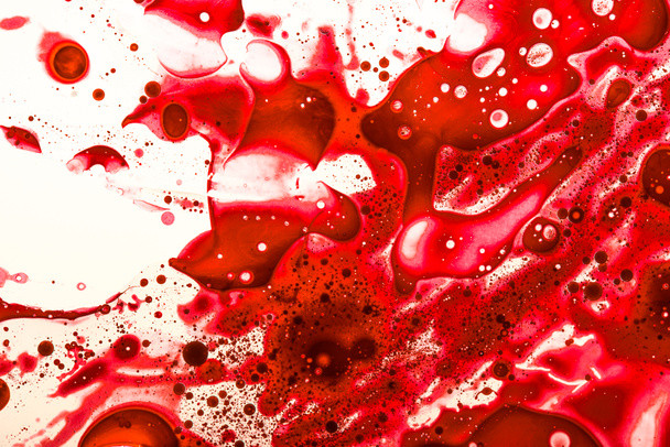 Studio shot of blood splashes on white surface - Foto, Bild