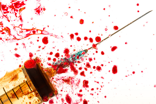 Close up view of syringe and blood on white - Foto, Imagem