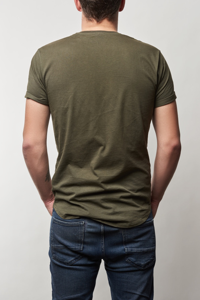 back view of man in khaki t-shirt with copy space isolated on grey - Foto, Bild
