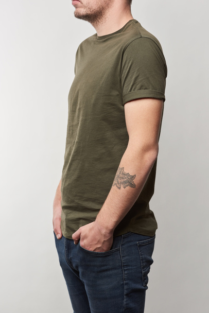 cropped view of tattooed man in khaki t-shirt with copy space isolated on grey - Φωτογραφία, εικόνα