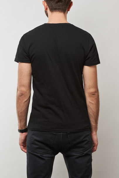 back view of man in black t-shirt with copy space isolated on grey - Φωτογραφία, εικόνα
