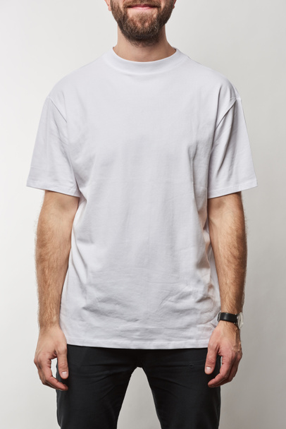 partial view of man in white t-shirt with copy space isolated on grey - Фото, изображение