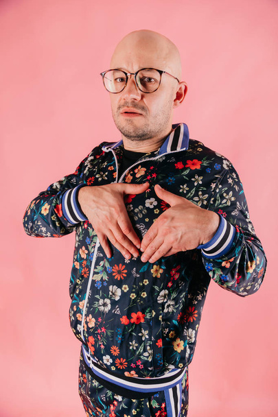 young man in fashionable clothes posing on pink background - Valokuva, kuva