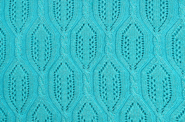Bezešvé pletené béžová textilie textura s copánky. Opakující se stroj pletení textury svetr. Béžová pletená pozadí. - Fotografie, Obrázek