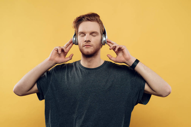Young Man Listening to Music With Headphones - Foto, afbeelding