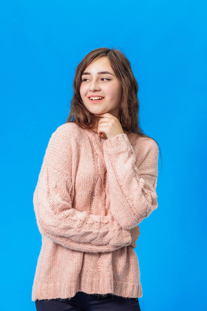 Young beautiful girl isolated on blue background - Фото, зображення
