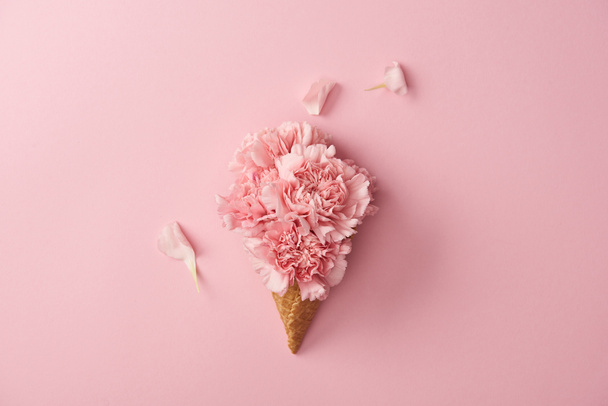 beautiful pink carnation flowers in wafer cone isolated on pink  - Photo, Image