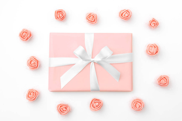 Mother's day greeting card with decorated coral or pink rose flowers and coral gift box isolated on white background. 8 March Women day concept pattern. Top view. Flat lay - Φωτογραφία, εικόνα