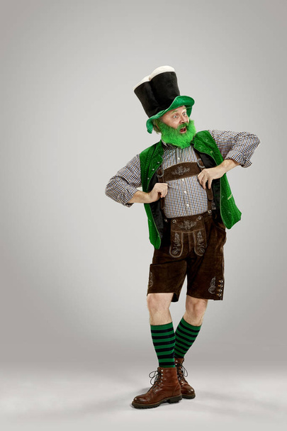 A man in a leprechaun hat at studio. He celebrates St. Patricks Day. - Φωτογραφία, εικόνα