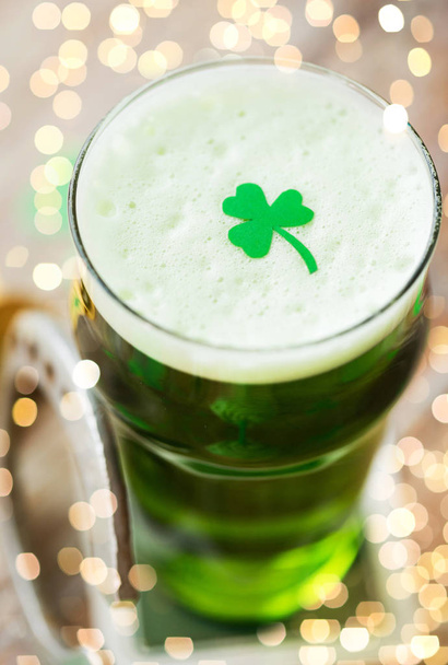 close up of glass of green beer with shamrock - Foto, immagini