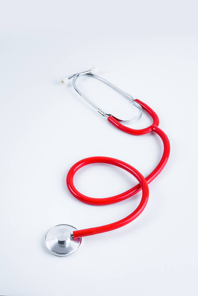 Red heart and stethoscope on white table with copy space - Foto, immagini