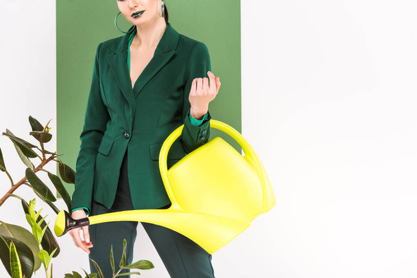 cropped view of stylish woman holding watering can and posing with sea green on background - Φωτογραφία, εικόνα