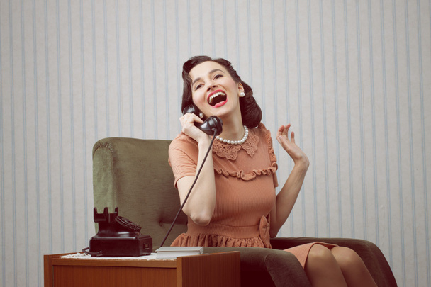 Cheerful woman talking on landline phone - Foto, Imagem