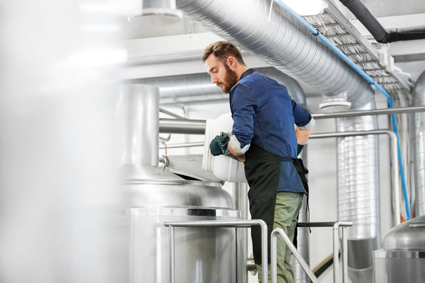 man working at craft brewery or beer plant - Fotoğraf, Görsel