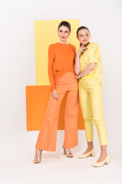 beautiful stylish young women posing with turmeric and limelight on background - Foto, Imagem