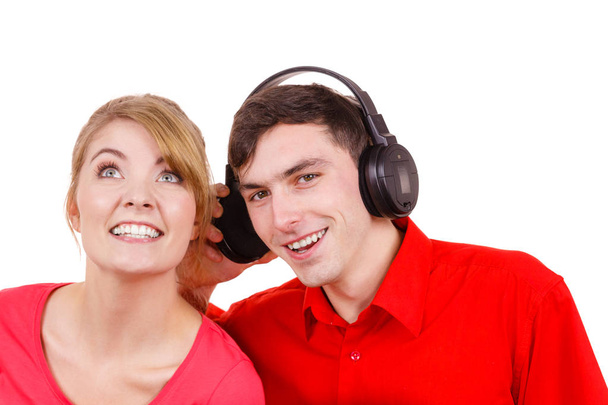 Couple two friends with big headphones listening to music mp3 together. Joyful happy woman and man on white. People leisure happiness concept.  - Фото, изображение