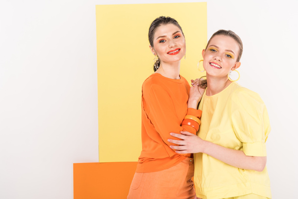 beautiful stylish girls posing and smiling with turmeric and limelight on background - Photo, Image