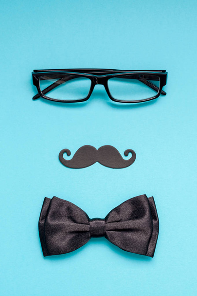 Creative flatlay overhead top view retro stylish black paper photo booth props moustaches turquoise background copy space. Men health awareness month fathers day masculinity concept blog social media - Photo, Image