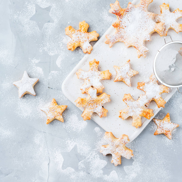 Food and drink, holidays concept. Homemade christmas snowflake cookies on a cozy kitchen table. Top view flat lay background - Photo, Image