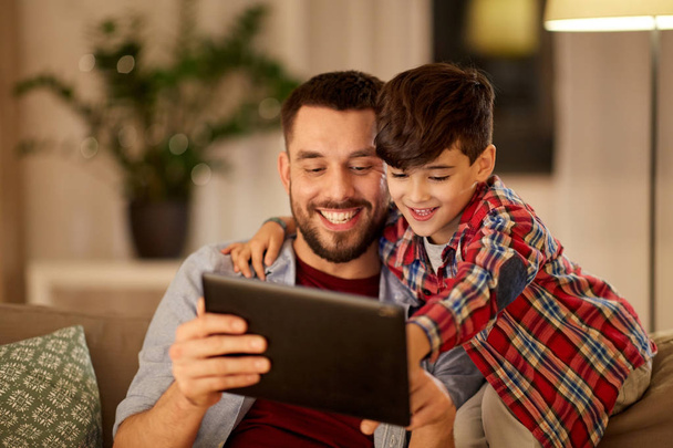 father and son with tablet pc playing at home - Foto, Imagen