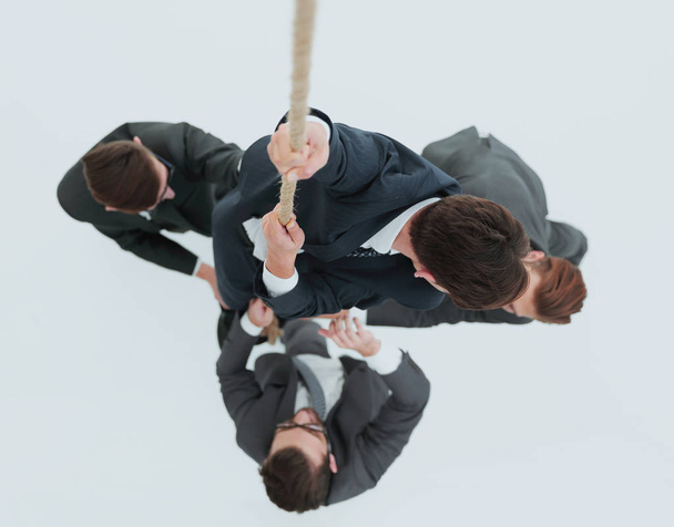top view .business team helps the leader to climb up. - Fotografie, Obrázek