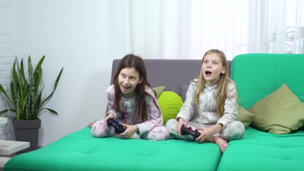kids playing with game consoles - Materiał filmowy, wideo
