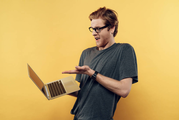 Astonished Man in Glasses Looking at Laptop Screen - Фото, изображение