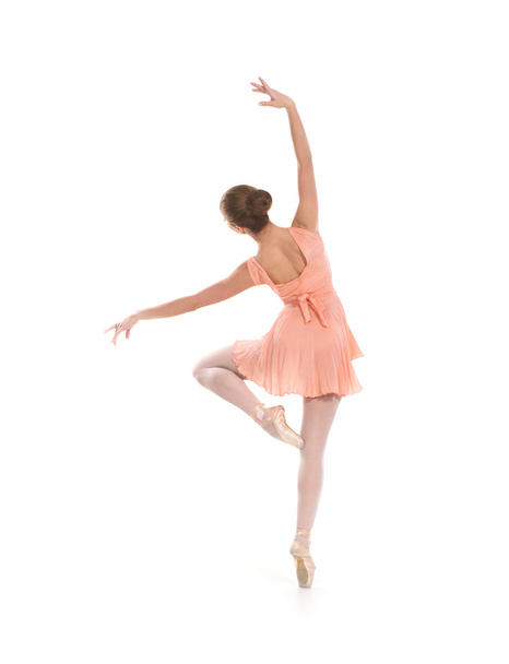 A young ballet dancer in a light dress on a white background - Fotó, kép